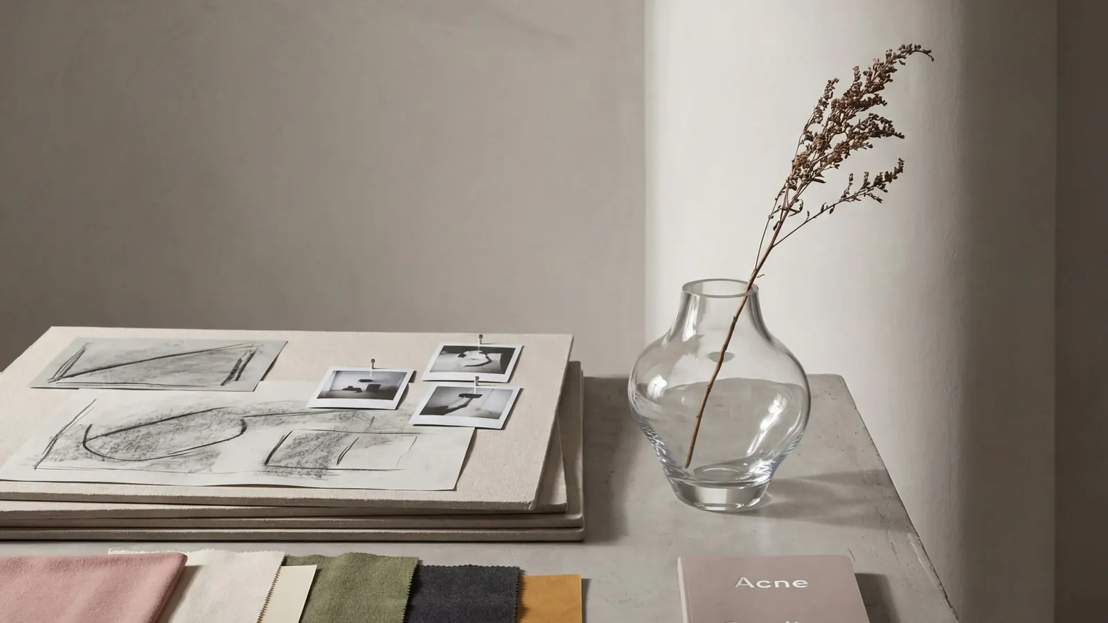 Fabric swatches, sketches and a vase on a designer's table